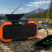 Qinux Brick Pro emergency radio charging a smartphone outdoors