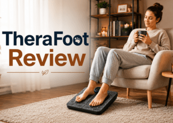 Person using TheraFoot EMS massager for foot pain relief in living room.