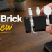 CordBrick weighted cord holder organizing cables on a wooden desk