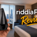 Riddiapress Review (2026): Is This Cordless Travel Iron Actually Worth It? 9 A person holding the black riddiaPress cordless travel iron in a hotel room.